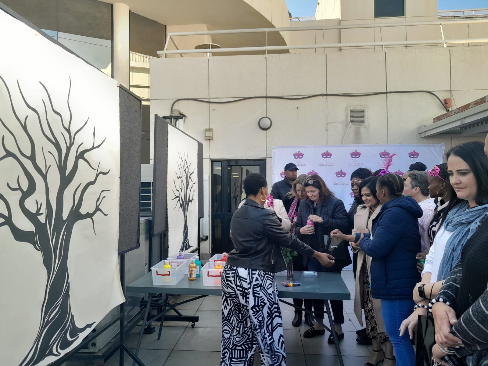 Picture of guests placing their hand prints on a Tree Canvas. Picture of guests placing their hand prints on a Tree Canvas.