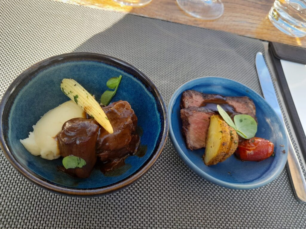 Main course rich wine braised oxtail and chalmar beef rib eye Main course rich wine braised oxtail and chalmar beef rib eye