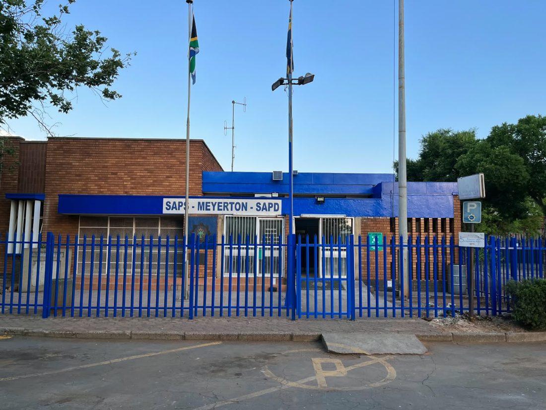 Meyerton police station after the project, with freshly painted blue palisade fence and entrance wall